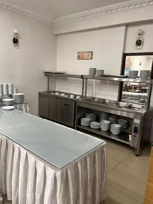 a kitchen with a counter with plates and bowls at Adil Konak Hotel in Istanbul