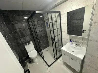 a bathroom with a shower and a toilet and a sink at Royal Suit in Bandırma