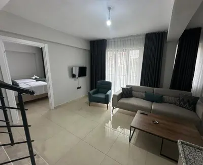 a living room with a couch and a bed at Royal Suit in Bandırma