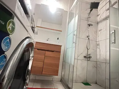 a bathroom with a shower and a washing machine at Konakkoy 1 in Istanbul