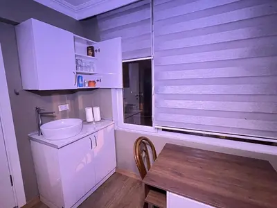 a white bathroom with a sink and a table at Konakkoy 1 in Istanbul