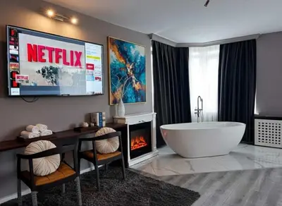 a bathroom with a tub and a tv and a fireplace at Treekos Boutique Hotel Istanbul Airport in Karaburun