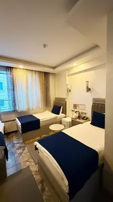 a hotel room with two beds and a room with at Kurban Otel in Istanbul