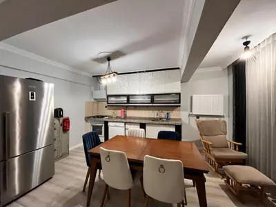 a kitchen and dining room with a wooden table and chairs at Quiet House in İznik