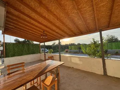 a wooden table and chairs under a wooden pergola at Quiet House in İznik