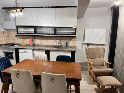 a kitchen and dining room with a wooden table and chairs at Quiet House in İznik
