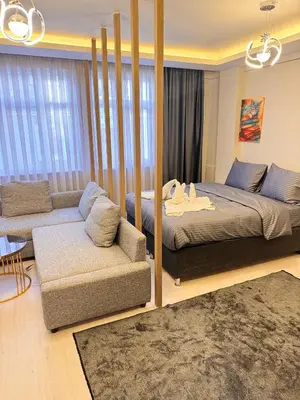 a bedroom with a large bed and a couch at The Old Bazaar Suites Apartment in Istanbul