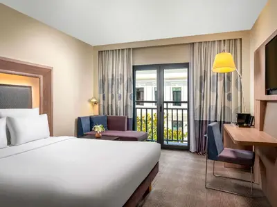 a hotel room with a bed and a chair and a desk at Novotel Istanbul Bosphorus Hotel in Istanbul