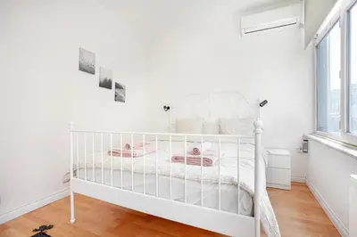 a white crib in a white room with a window at Magnificent View Great Location in Istanbul