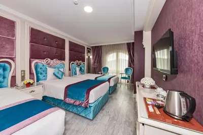 a hotel room with two beds and a television at Marnas Hotels in Istanbul