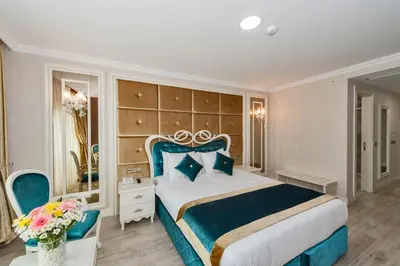 a bedroom with a blue and white bed and a mirror at Marnas Hotels in Istanbul