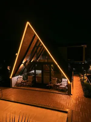 a group of chairs sitting on a deck at night at Zeyno Sapanca in Sapanca