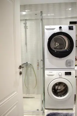 a washer and dryer in a bathroom with a shower at My Glamorous Stay at Kadikoy Istanbul Türkiye in Istanbul