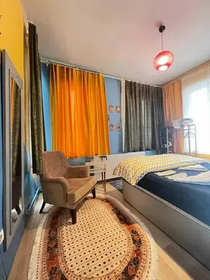a bedroom with a bed and a chair and a window at Taksim Square home in Istanbul