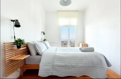 a white bedroom with a bed and a window at Historic Elegance with a Bosphorus Gaze in Istanbul
