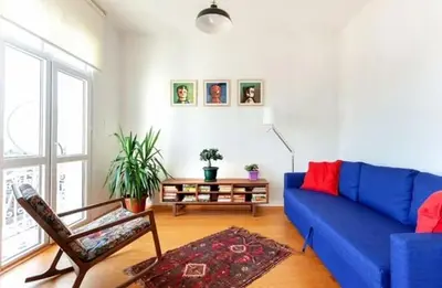 a living room with a blue couch and a chair at Historic Elegance with a Bosphorus Gaze in Istanbul