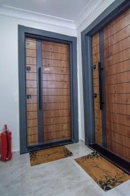 two wooden doors in a room with mats at Cozy 1BR with Inviting Balcony in Beylikduzu