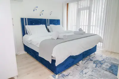 a bedroom with a large bed with white pillows at Cozy 1BR with Inviting Balcony in Beylikduzu