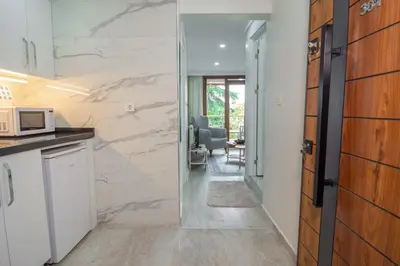 a kitchen with a door leading to a living room at Cozy 1BR & Sofabed with Two Inviting Balconies in Beylikduzu