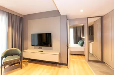 a room with a tv and a chair and a mirror at QUİ Hotel&SPA in Istanbul