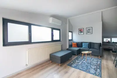 a living room with a couch and a table at Modern Duplex with Large Terrace in Cihangir in Istanbul