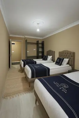 a row of three beds in a room at Loft House Studio in Arnavutköy