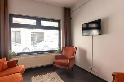 a living room with a chair and a window at Eclectic 1BR with Charm in the Heart of Cihangir in Istanbul