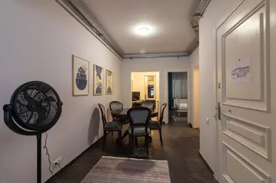 a room with a table and chairs and a fan at Eclectic 1BR with Charm in the Heart of Cihangir in Istanbul