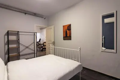 a bedroom with a white bed and a mirror at Eclectic 1BR with Charm in the Heart of Cihangir in Istanbul