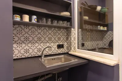 a kitchen counter with a sink and a mirror at Eclectic 1BR with Charm in the Heart of Cihangir in Istanbul
