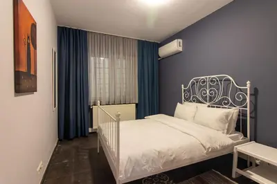 a bedroom with a white bed and blue walls at Eclectic 1BR with Charm in the Heart of Cihangir in Istanbul