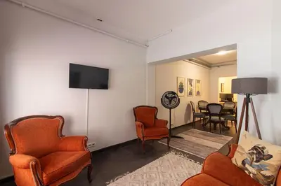 a living room with chairs and a flat screen tv at Eclectic 1BR with Charm in the Heart of Cihangir in Istanbul