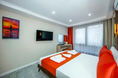 a hotel room with a bed with two towels at Cosinüs Airport Hotel in Arnavutköy