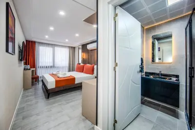 a hotel room with a bed and a bathroom at Cosinüs Airport Hotel in Arnavutköy
