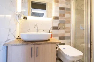 a bathroom with a sink and a toilet at The Wind Beşiktaş in Istanbul