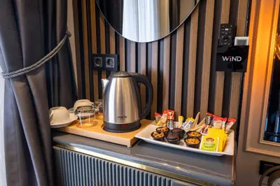 a table with a coffee maker and a plate of food at The Wind Beşiktaş in Istanbul