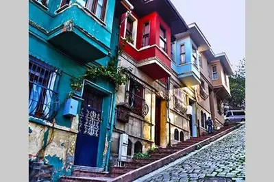 a row of colorful buildings on a cobblestone street at Private house with 4 separate apartments-for families & friend groups in Istanbul