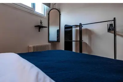 a bedroom with a bed and a mirror and a refrigerator at Luxury with Exceptional Terrace and Bosphorus View in Istanbul