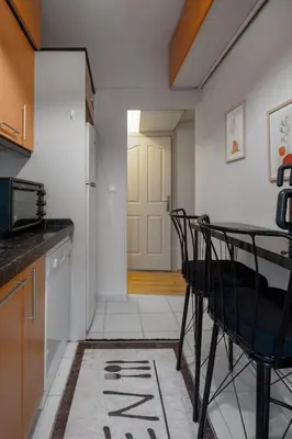 a kitchen with a table and chairs and a door at Luxury with Exceptional Terrace and Bosphorus View in Istanbul