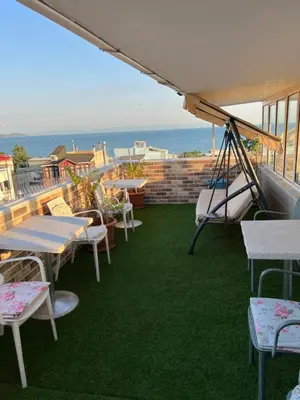a balcony with tables and chairs and a swing at My Holiday Time Hotel in Istanbul