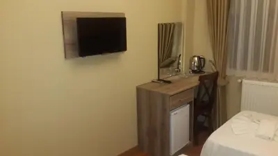 a hotel room with a television on the wall at My Holiday Time Hotel in Istanbul