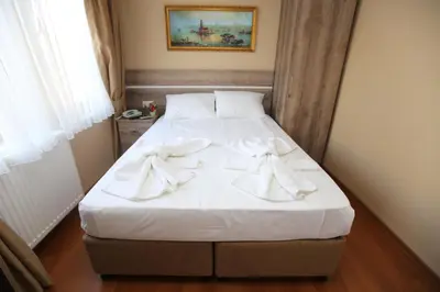 a bed with white towels on it in a room at My Holiday Time Hotel in Istanbul