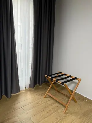 a wooden chair sitting in front of a window at Trio Houses in Istanbul