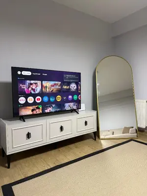 a room with a tv on a dresser with a mirror at Trio Houses in Istanbul