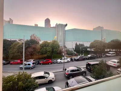 a parking lot with cars parked in front of a building at Next to Cevahir Shopping Mall Perfect location comfortable luxury apartment in Istanbul