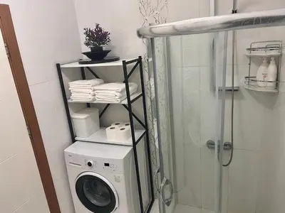 a bathroom with a washing machine and a shower at Next to Cevahir Shopping Mall Perfect location comfortable luxury apartment in Istanbul