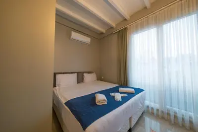 a bedroom with a bed with towels and a window at Country Life Sapanca in Sapanca