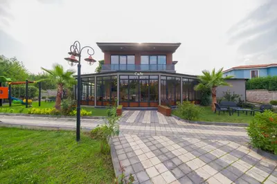 a house with a glass building in a park at Country Life Sapanca in Sapanca