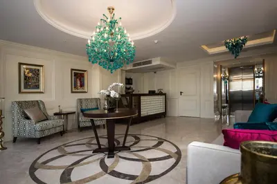 a living room with a table and a chandelier at Istanbul Town Hotel in Istanbul