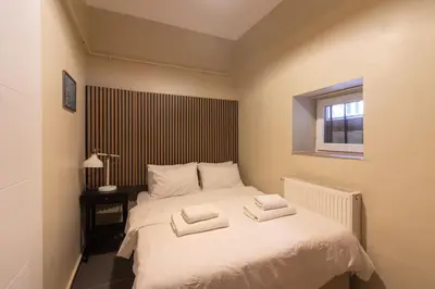a bedroom with a bed with two towels on it at Calm & Charming 1BR with Shared Lush Garden Access in Istanbul